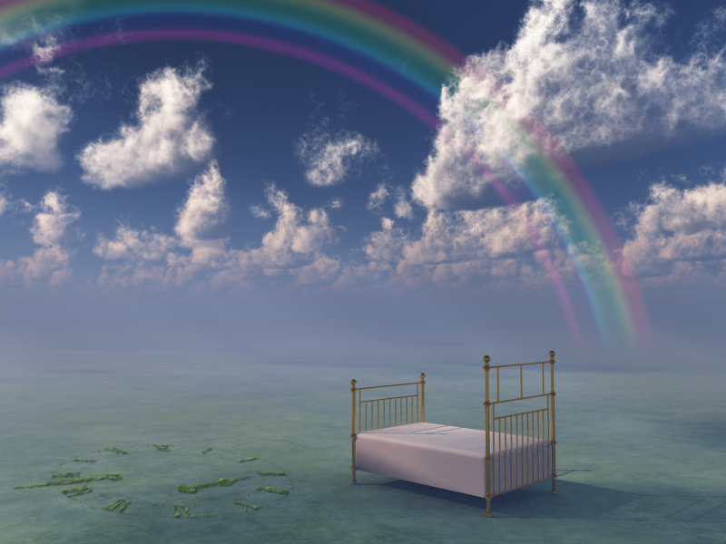 Bed in surreal peaceful landscape